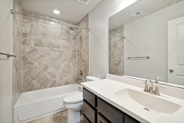 full bathroom with toilet, vanity, and tiled shower / bath