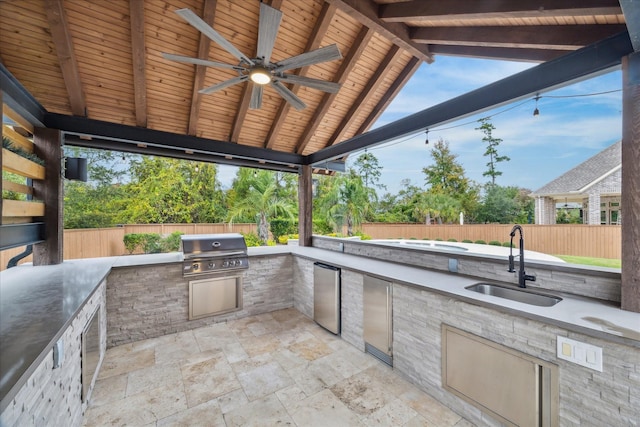 view of patio with sink, area for grilling, and ceiling fan