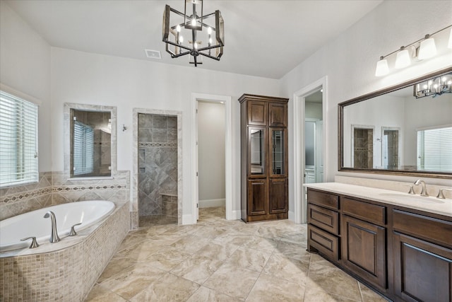 bathroom with a chandelier, independent shower and bath, and vanity