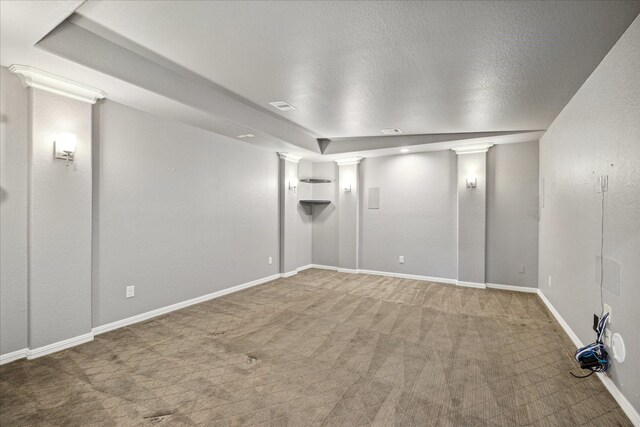 carpeted empty room with a textured ceiling