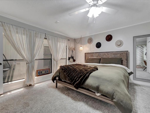 carpeted bedroom featuring ceiling fan and crown molding