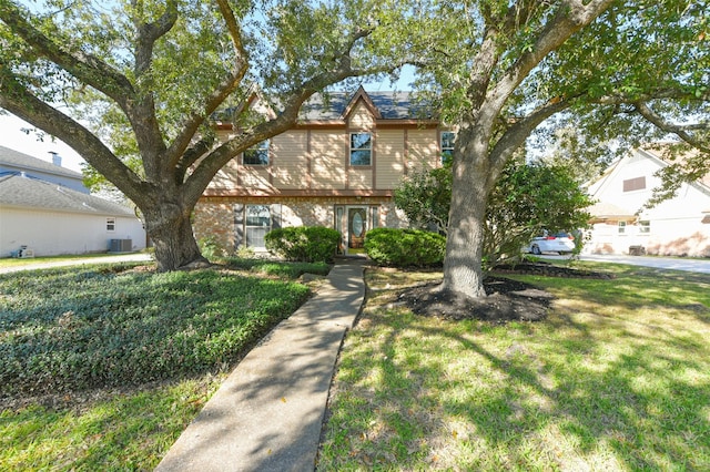 view of front of house featuring a front lawn and central air condition unit