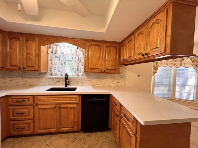 kitchen featuring dishwasher, plenty of natural light, sink, and a tray ceiling