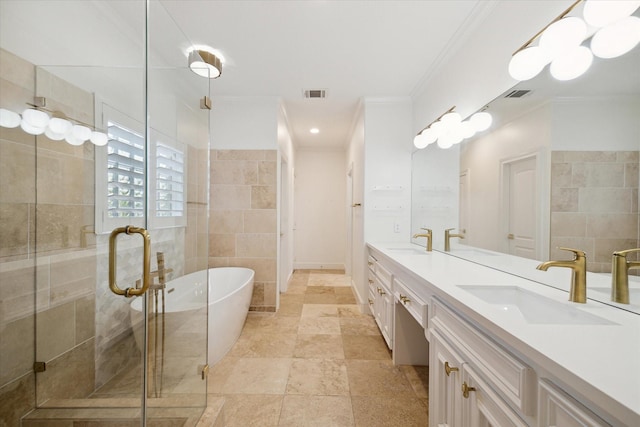 bathroom with vanity, ornamental molding, tile walls, and separate shower and tub