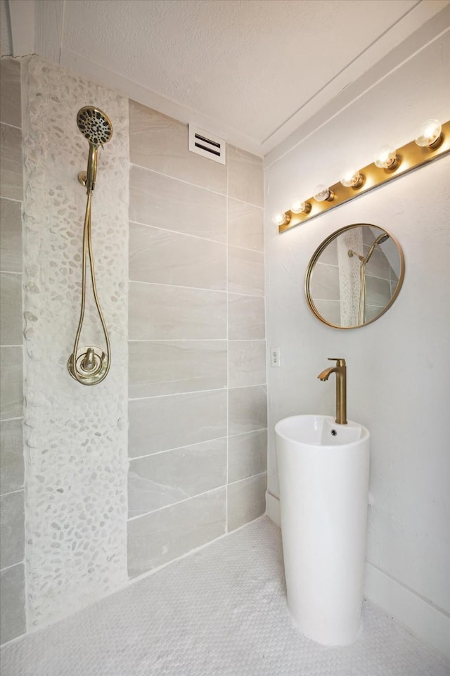 bathroom with tile patterned floors and a textured ceiling