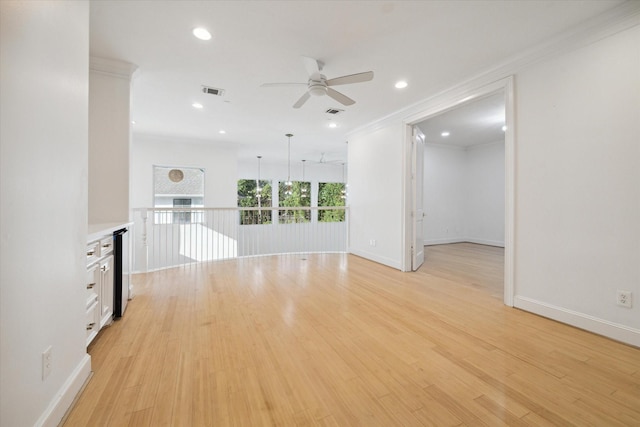 1406 Sue Barnett Dr, Houston, TX 77018 - empty room featuring a ceiling fan, ornamental molding, recessed lighting, light wood-type flooring, and baseboards