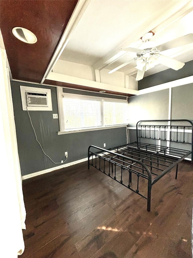 bedroom featuring hardwood / wood-style floors, ceiling fan, and a wall mounted AC