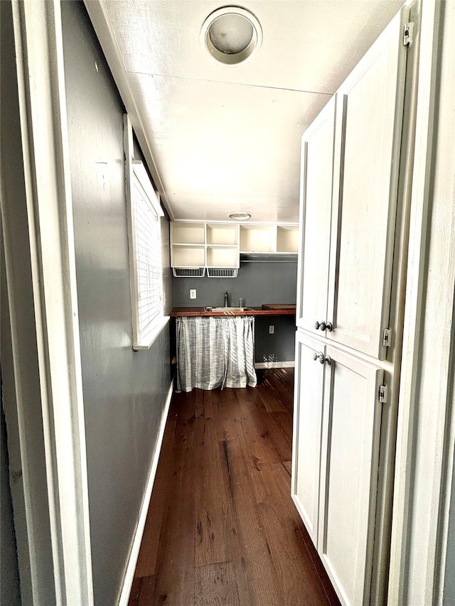 hallway featuring dark hardwood / wood-style flooring and sink