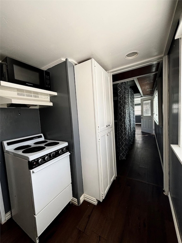 kitchen featuring dark hardwood / wood-style floors, white cabinetry, and electric stove