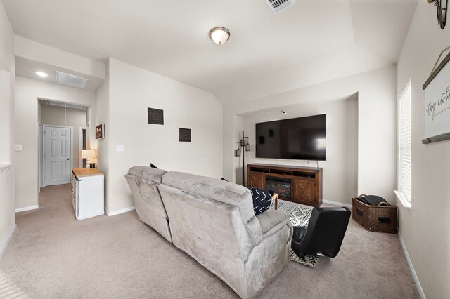 carpeted living room with vaulted ceiling