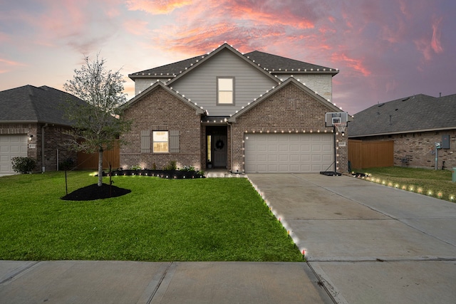 view of front property with a yard and a garage