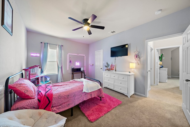 bedroom with ceiling fan and light colored carpet