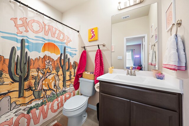 bathroom with a shower with shower curtain, vanity, wood-type flooring, and toilet