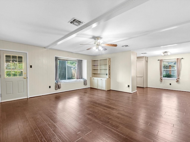 unfurnished living room with built in shelves, dark hardwood / wood-style floors, ceiling fan, and a healthy amount of sunlight