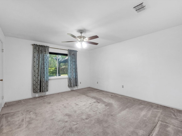 carpeted spare room with ceiling fan