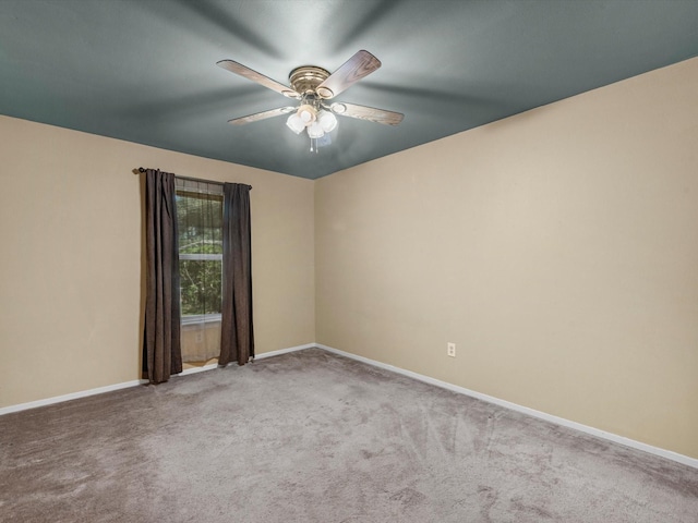 spare room featuring ceiling fan and carpet floors