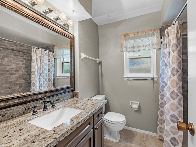 bathroom featuring tile patterned floors, vanity, toilet, and walk in shower