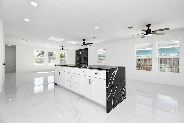 kitchen with white cabinets and a wealth of natural light