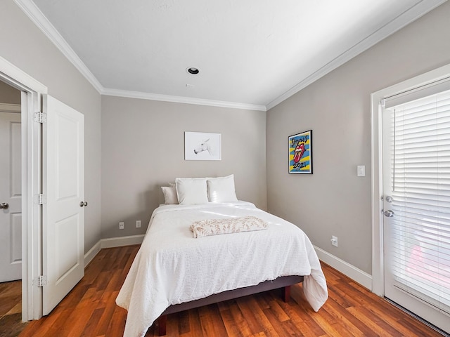 bedroom featuring crown molding and dark wood-type flooring