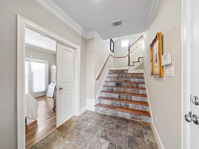 stairway with hardwood / wood-style floors and crown molding