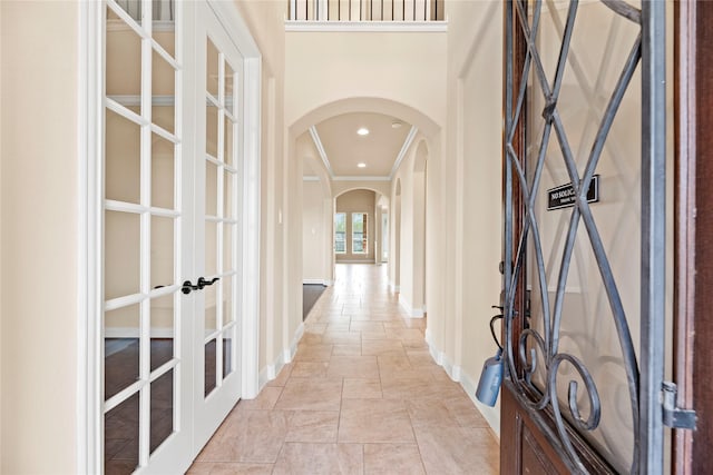 hall with crown molding and french doors