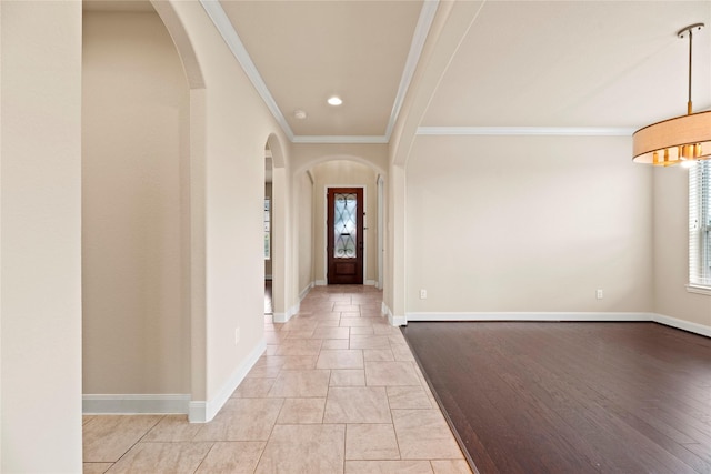 foyer entrance with crown molding and light hardwood / wood-style flooring