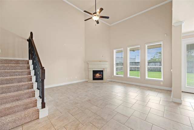 unfurnished living room with light tile patterned floors, high vaulted ceiling, ceiling fan, and ornamental molding