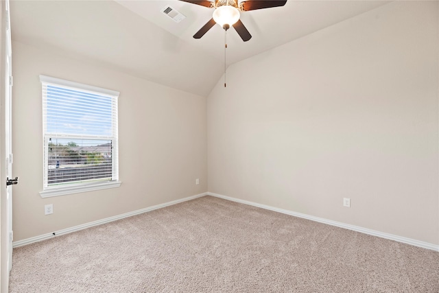 carpeted empty room featuring ceiling fan and lofted ceiling