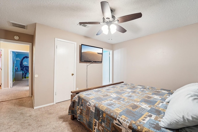 carpeted bedroom featuring a textured ceiling and ceiling fan