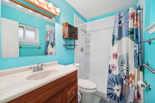 bathroom with a shower with curtain, tile patterned flooring, a textured ceiling, toilet, and vanity