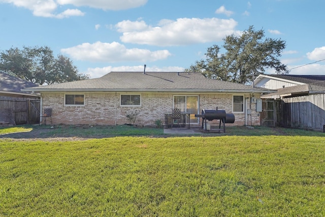 back of house with a patio area and a lawn