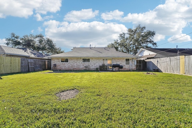 rear view of house with a lawn