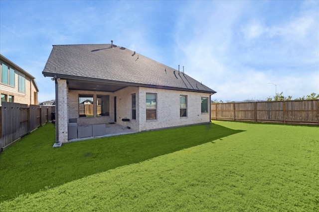 rear view of house with a yard