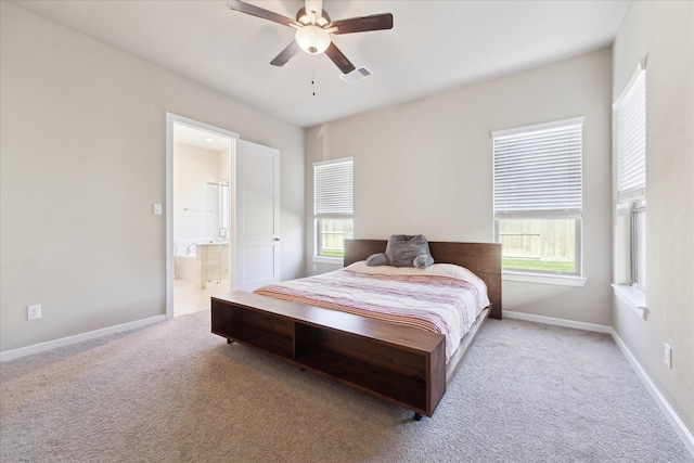 carpeted bedroom with ceiling fan and ensuite bathroom