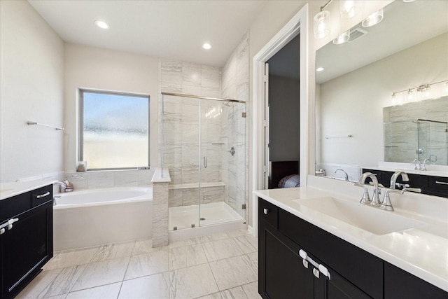 bathroom featuring shower with separate bathtub and vanity