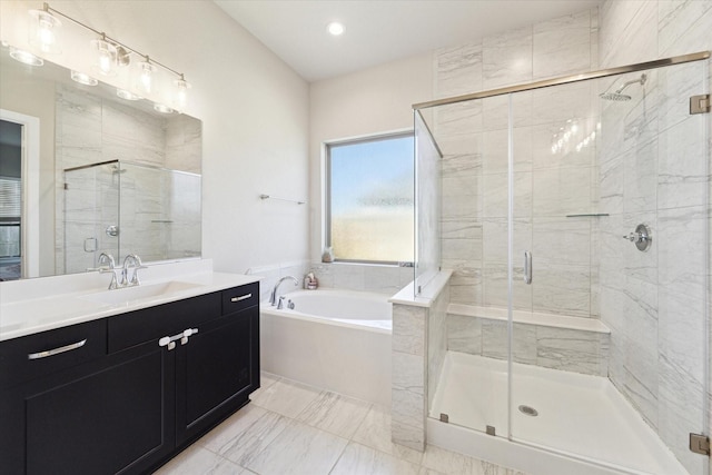 bathroom featuring vanity and independent shower and bath