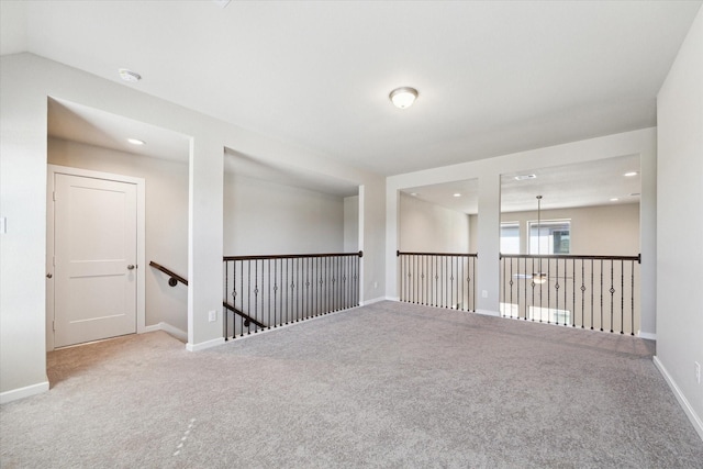 unfurnished room featuring carpet flooring and lofted ceiling