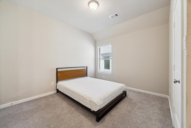 carpeted bedroom with vaulted ceiling