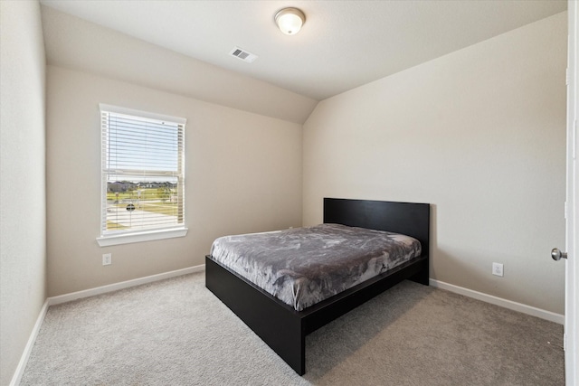 carpeted bedroom featuring vaulted ceiling