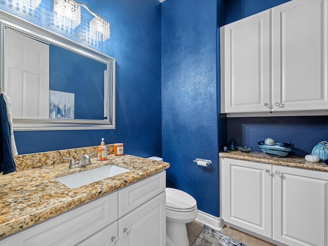 bathroom featuring tile patterned floors, vanity, and toilet