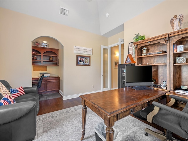 home office featuring dark hardwood / wood-style flooring and vaulted ceiling