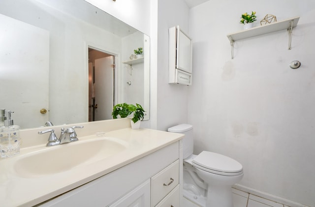 bathroom featuring tile patterned floors, vanity, and toilet