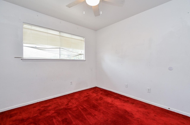 empty room featuring carpet flooring and ceiling fan