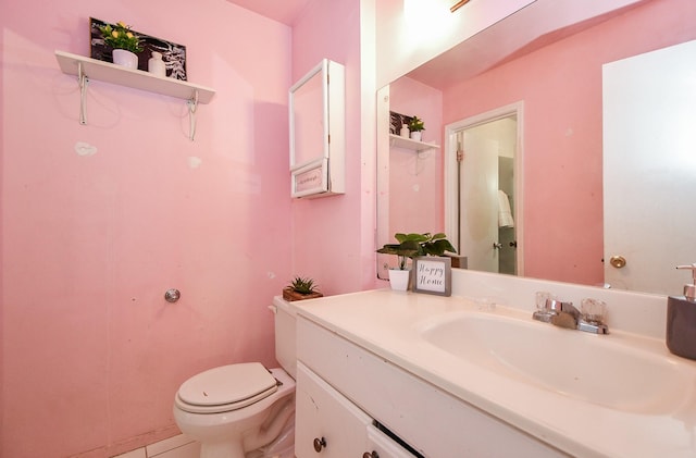 bathroom featuring tile patterned floors, vanity, and toilet