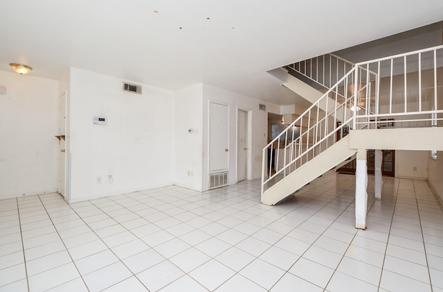 unfurnished living room featuring tile patterned floors