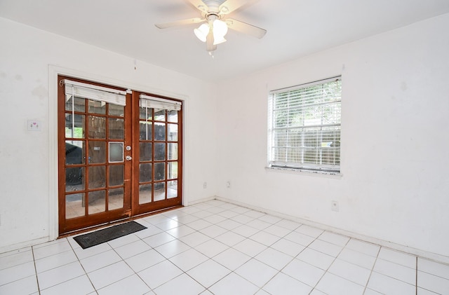 spare room featuring french doors, light tile patterned floors, and ceiling fan