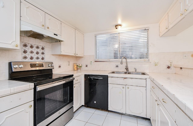 kitchen with white cabinetry, tile countertops, stainless steel electric range oven, and black dishwasher