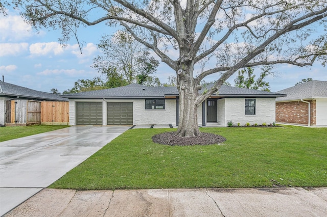 single story home with a front yard and a garage