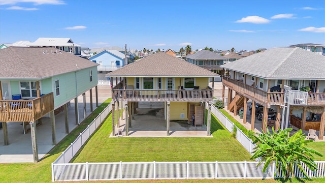 back of house with a lawn and a patio