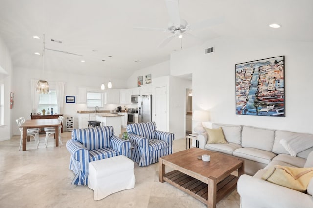 living room featuring ceiling fan and high vaulted ceiling